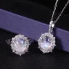 ArtistA Abiding 925 Sterling Silver White Cz Halo Oval Cut 8X10mm Milky Blue Moonstone Cluster Flower Ring Necklace Pendant Jewelry Set
